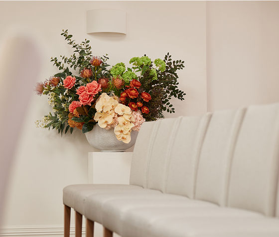 funeral director arranging flowers